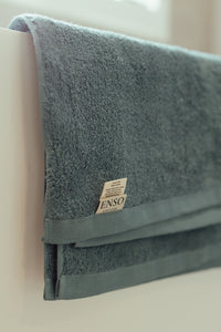 Gray towel with a brand label on a light background